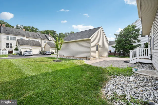 a view of a house with a yard and sitting area