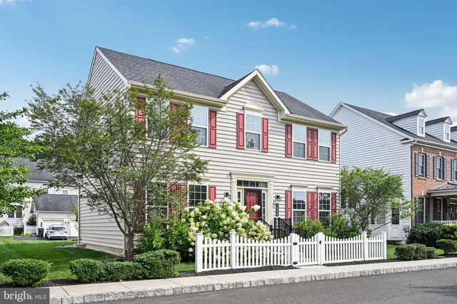 a front view of a house with a yard and potted plants