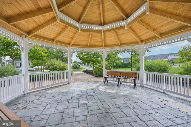 a view of a patio with a table and chairs under an umbrella