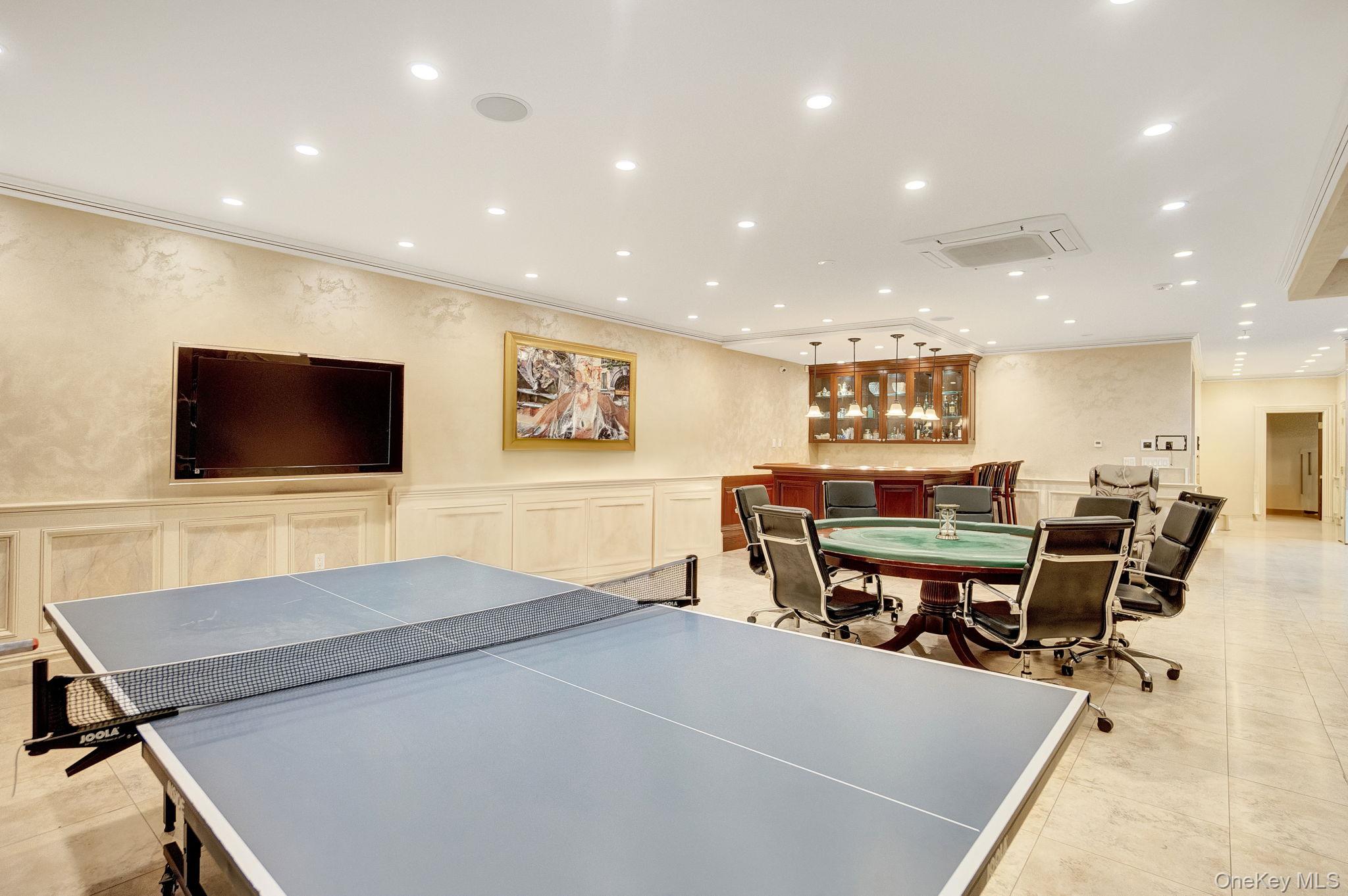 181-30 Tudor Road Queens, NY 11432 - Photo 35 of 46 Rec room featuring recessed lighting, a wainscoted wall, ornamental molding, and a decorative wall