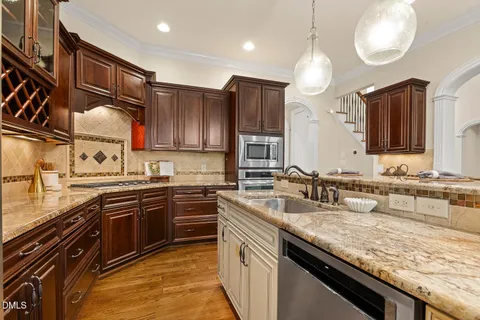 a kitchen with granite countertop a stove and a microwave