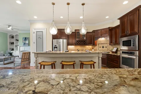 a kitchen with stainless steel appliances granite countertop a sink and cabinets