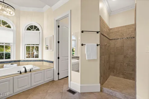 a dining room with wooden floor and windows