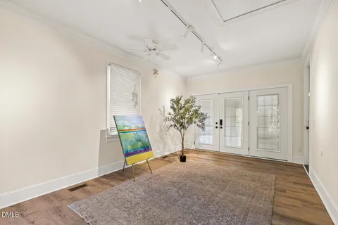 a view of an empty room with wooden floor