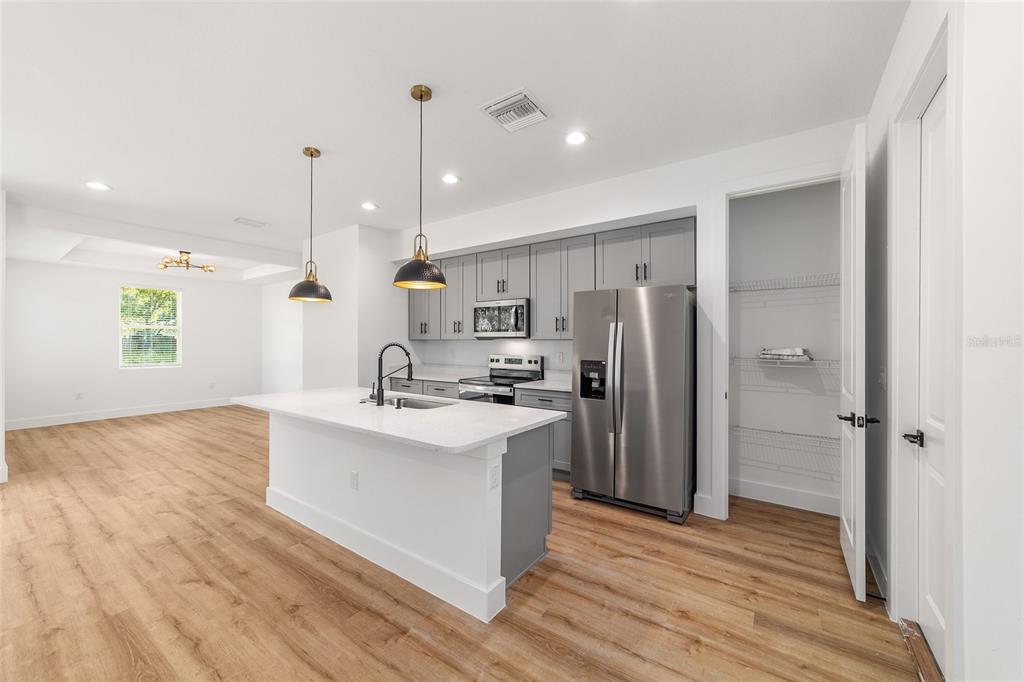 7 Oak Trail Ocala, FL 34472 - Photo 27 of 73 a kitchen with kitchen island a sink stainless steel appliances and cabinets