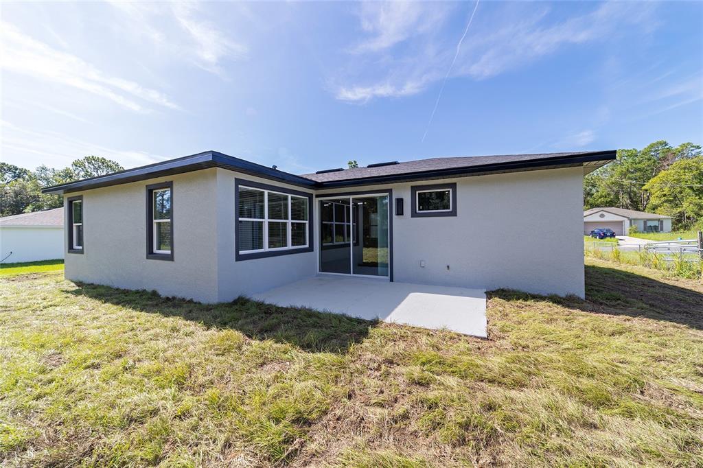 7 Oak Trail Ocala, FL 34472 - Photo 51 of 73 a front view of a house with a yard