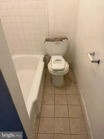 a bathroom with a toilet and a bathtub
