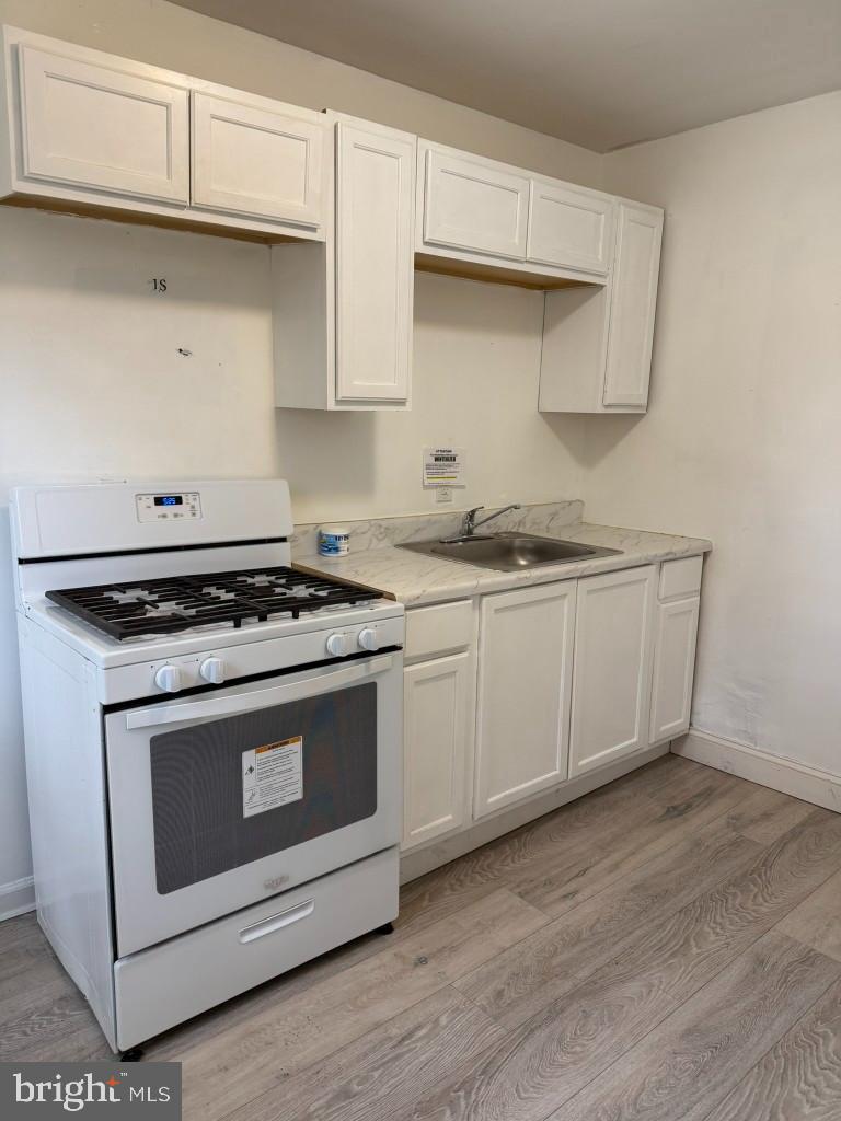 2464 Keyworth Avenue Baltimore, MD 21215 - Photo 15 of 36 a stove top oven sitting inside of a kitchen