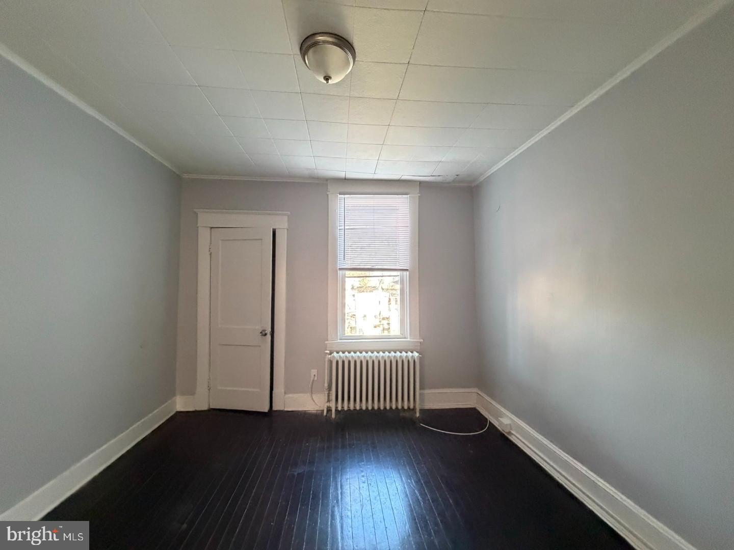2464 Keyworth Avenue Baltimore, MD 21215 - Photo 22 of 36 an empty room with wooden floor and windows