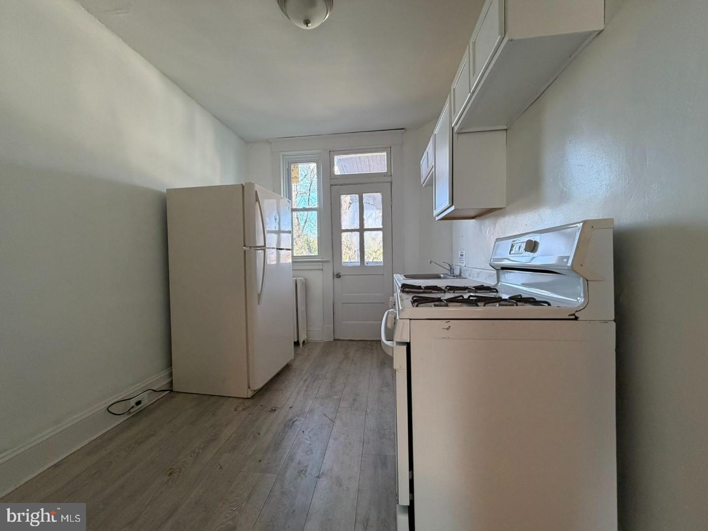 2464 Keyworth Avenue Baltimore, MD 21215 - Photo 24 of 36 a kitchen with refrigerator a stove and cabinets