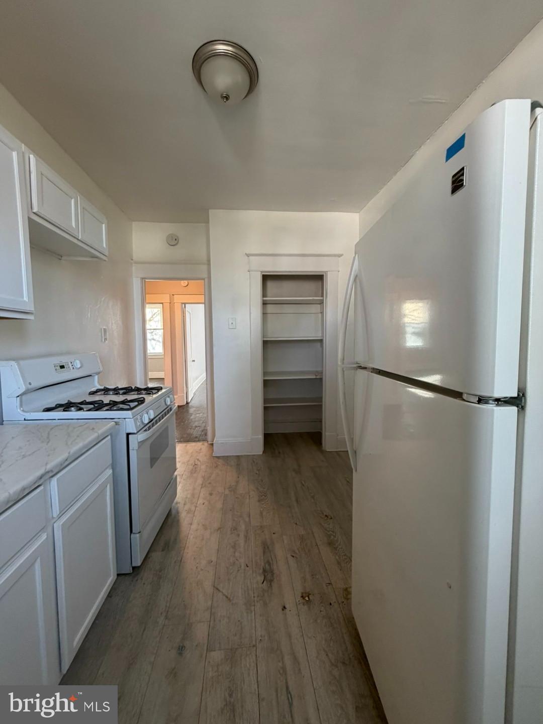 2464 Keyworth Avenue Baltimore, MD 21215 - Photo 27 of 36 a kitchen with a refrigerator and a stove
