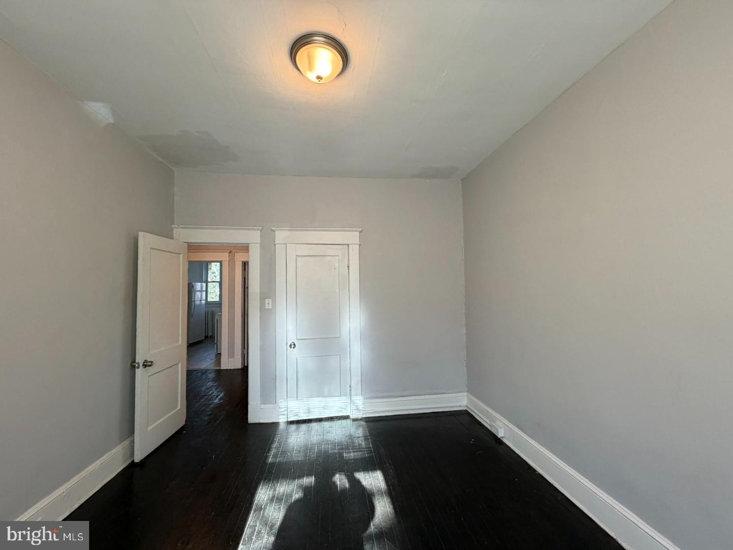 2464 Keyworth Avenue Baltimore, MD 21215 - Photo 31 of 36 an empty room with wooden floor and windows