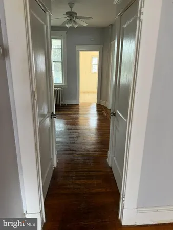 a view of a hallway view with wooden floor and staircase
