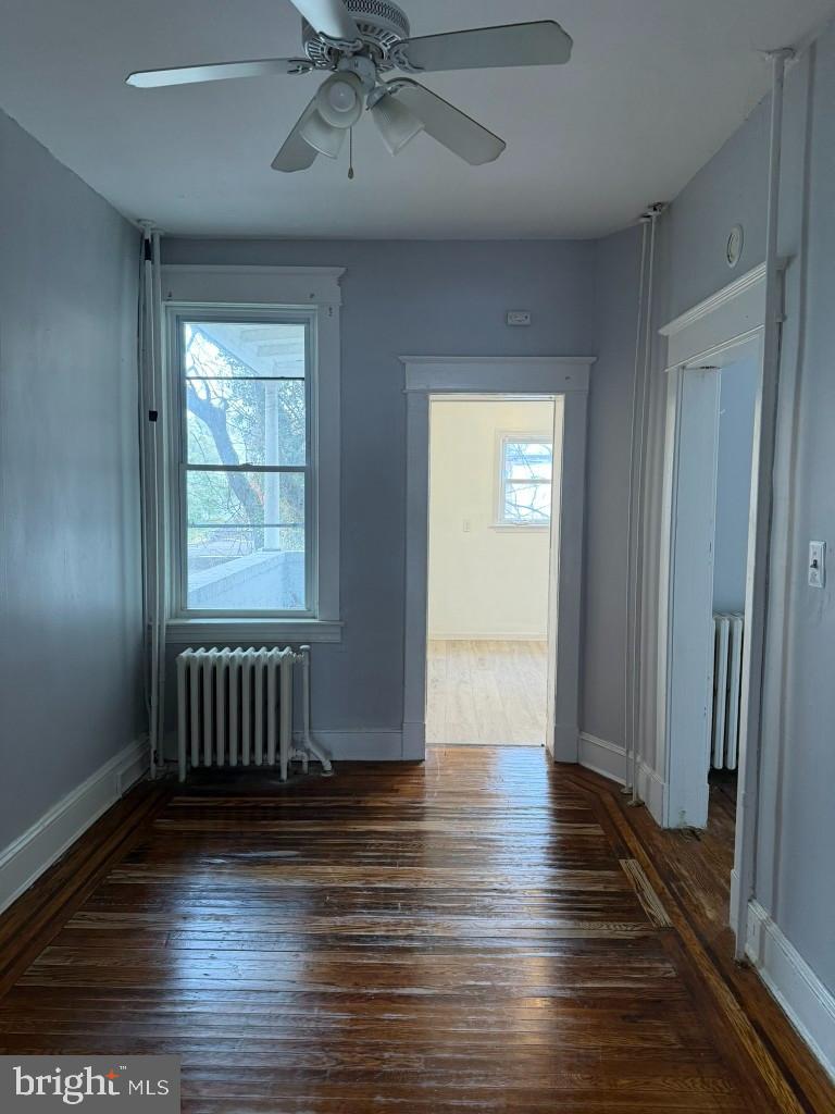 2464 Keyworth Avenue Baltimore, MD 21215 - Photo 10 of 36 an empty room with wooden floor closet and windows