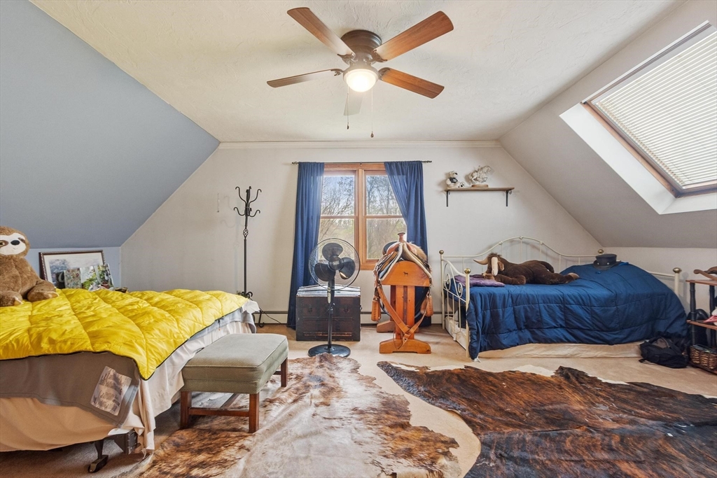 340 Ball Hill Road Princeton, MA 01541 - Photo 39 of 41 a bed room with a bed and a chandelier
