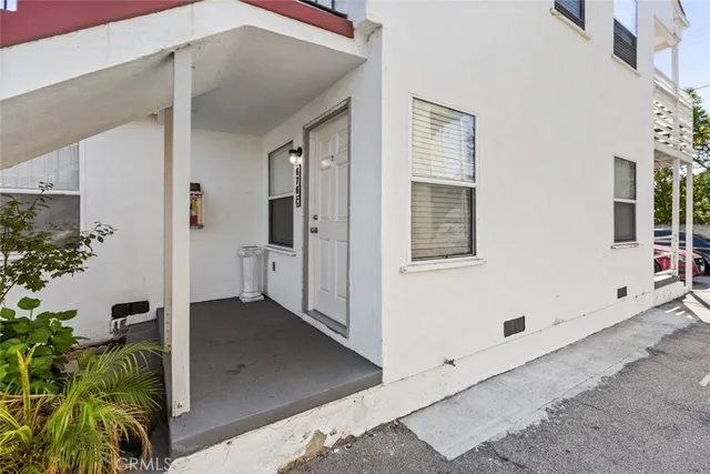 a view of a room with wooden floor and entryway