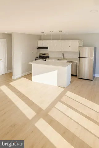 a view of a kitchen with a stove top oven and cabinets
