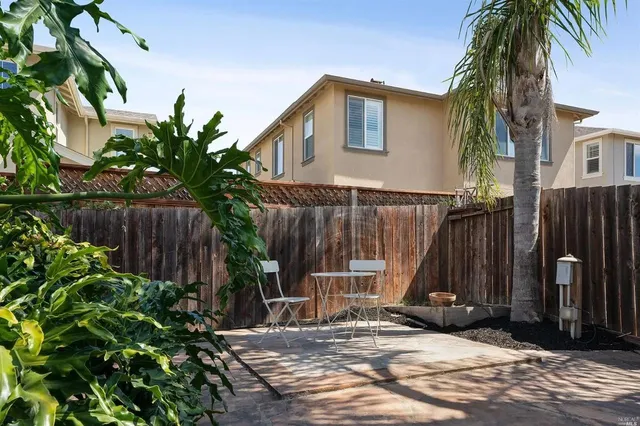 a view of a house with wooden fence