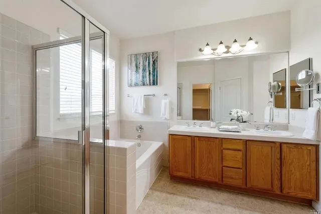 a bathroom with a tub sink and mirror