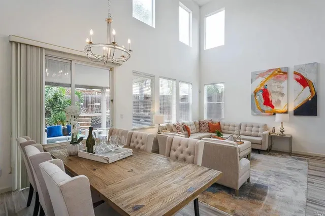 a living room with fireplace furniture and a chandelier