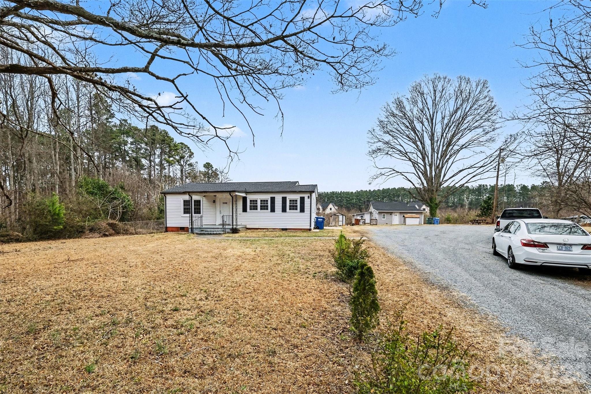 11733 Idlewild Road Matthews, NC 28105 - Photo 3 of 19 a view of a house with a yard covered with snow in front of house