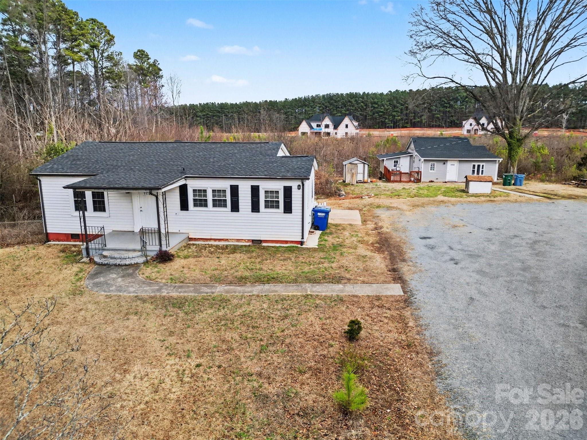 11733 Idlewild Road Matthews, NC 28105 - Photo 5 of 19 a view of a house with pool and a yard