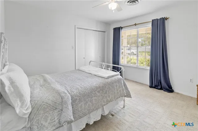 a spacious bedroom with a bed and a window