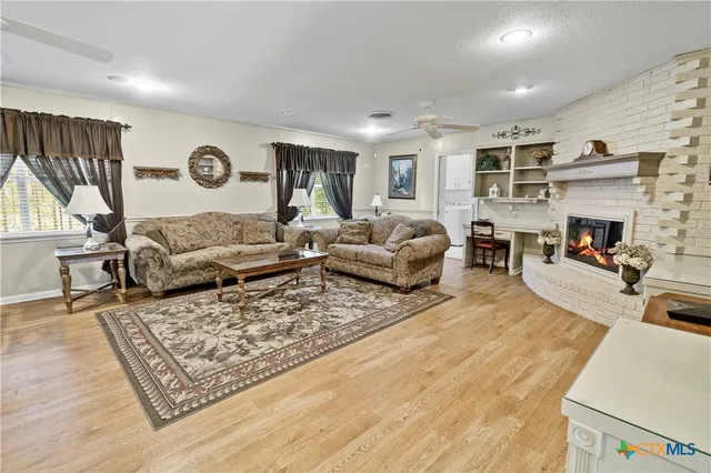 a living room with furniture fireplace and a table