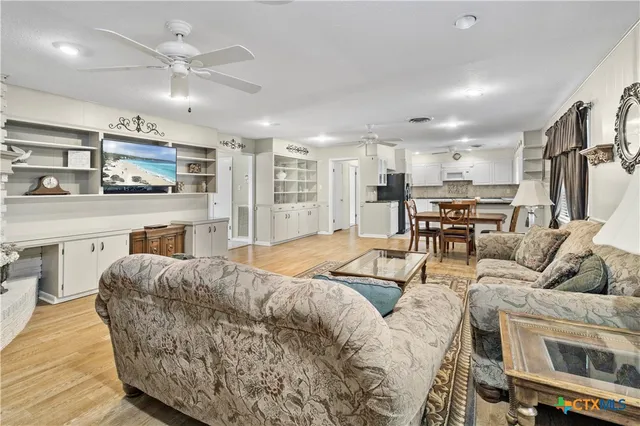 a living room with furniture and kitchen view