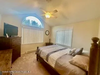 a bedroom with a bed and a television