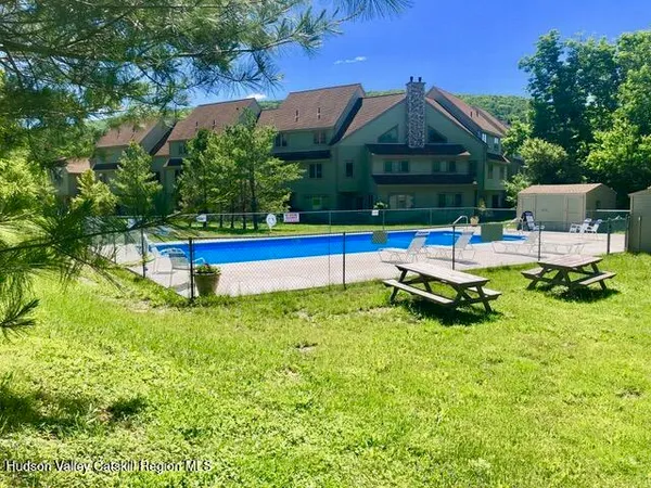 a backyard of a house with table and chairs