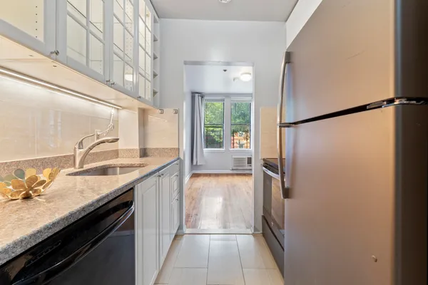 a kitchen with a sink and a refrigerator