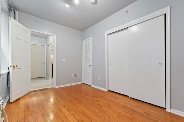 a view of a big room with closet and mirror