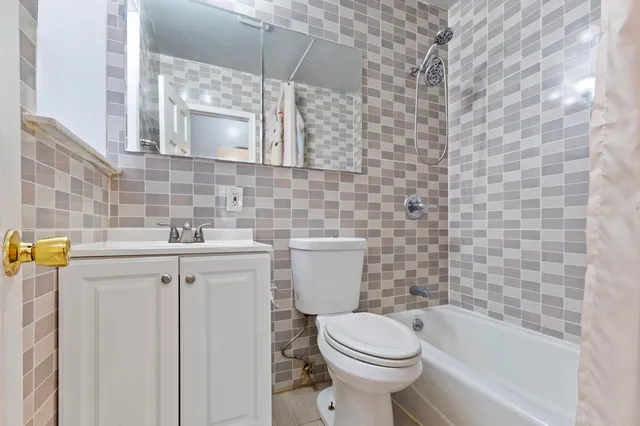 a bathroom with a sink a toilet and bathtub