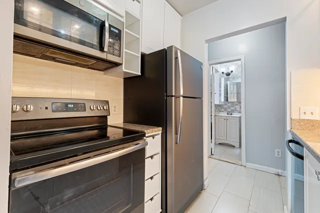 a kitchen with appliances and a refrigerator