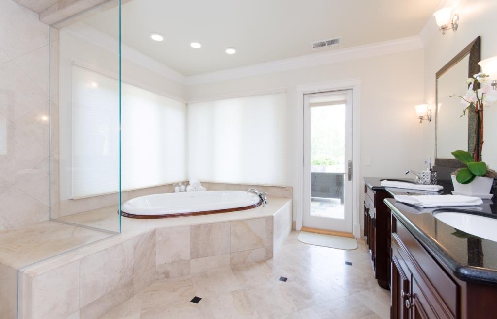 26990 Taaffe Road Los Altos Hills, CA 94022 - Photo 13 of 25 a spacious bathroom with a granite countertop sink a toilet a mirror and shower