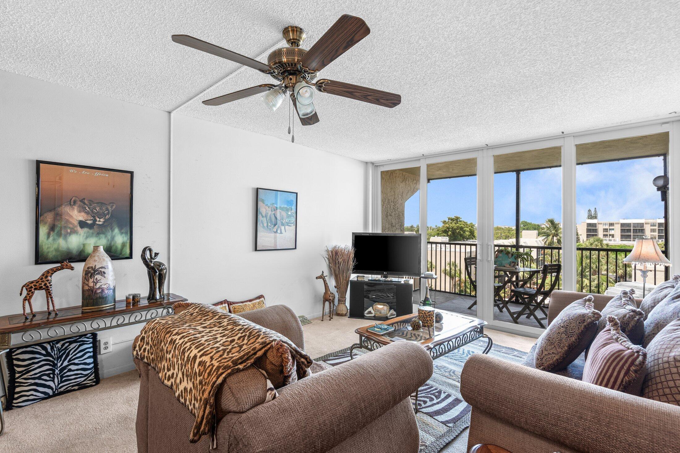 17 Royal Palm Way, Unit 504 Boca Raton, FL 33432 - Photo 15 of 44 a living room with furniture a ceiling fan and a window