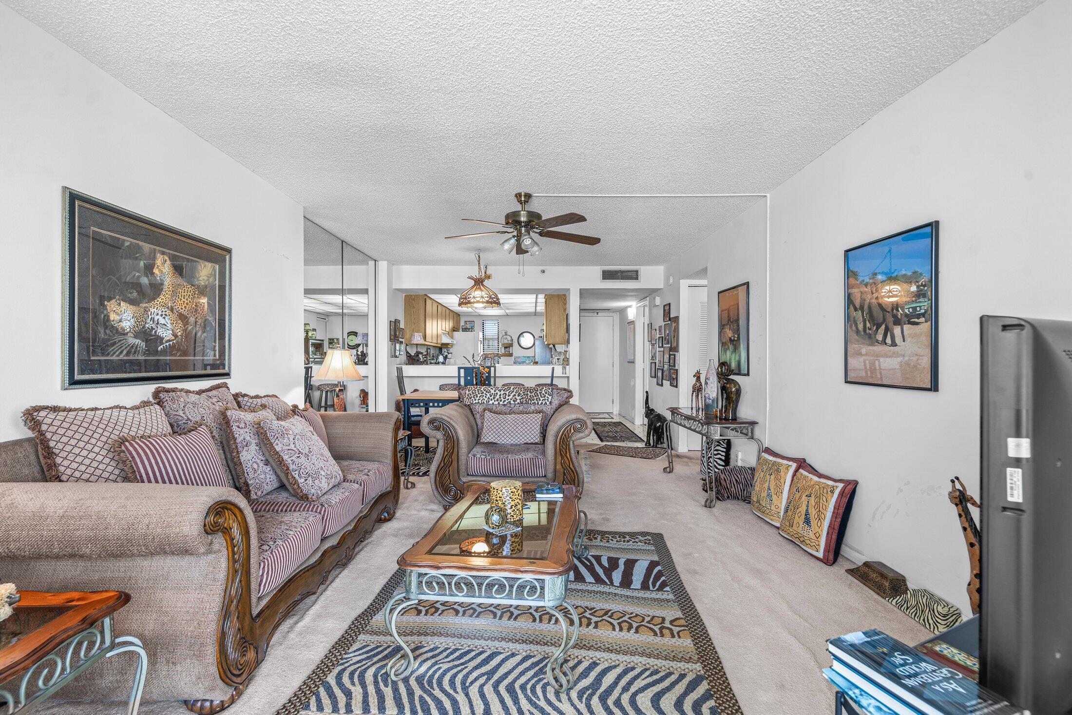 17 Royal Palm Way, Unit 504 Boca Raton, FL 33432 - Photo 17 of 44 a living room with furniture a rug and wall paintings