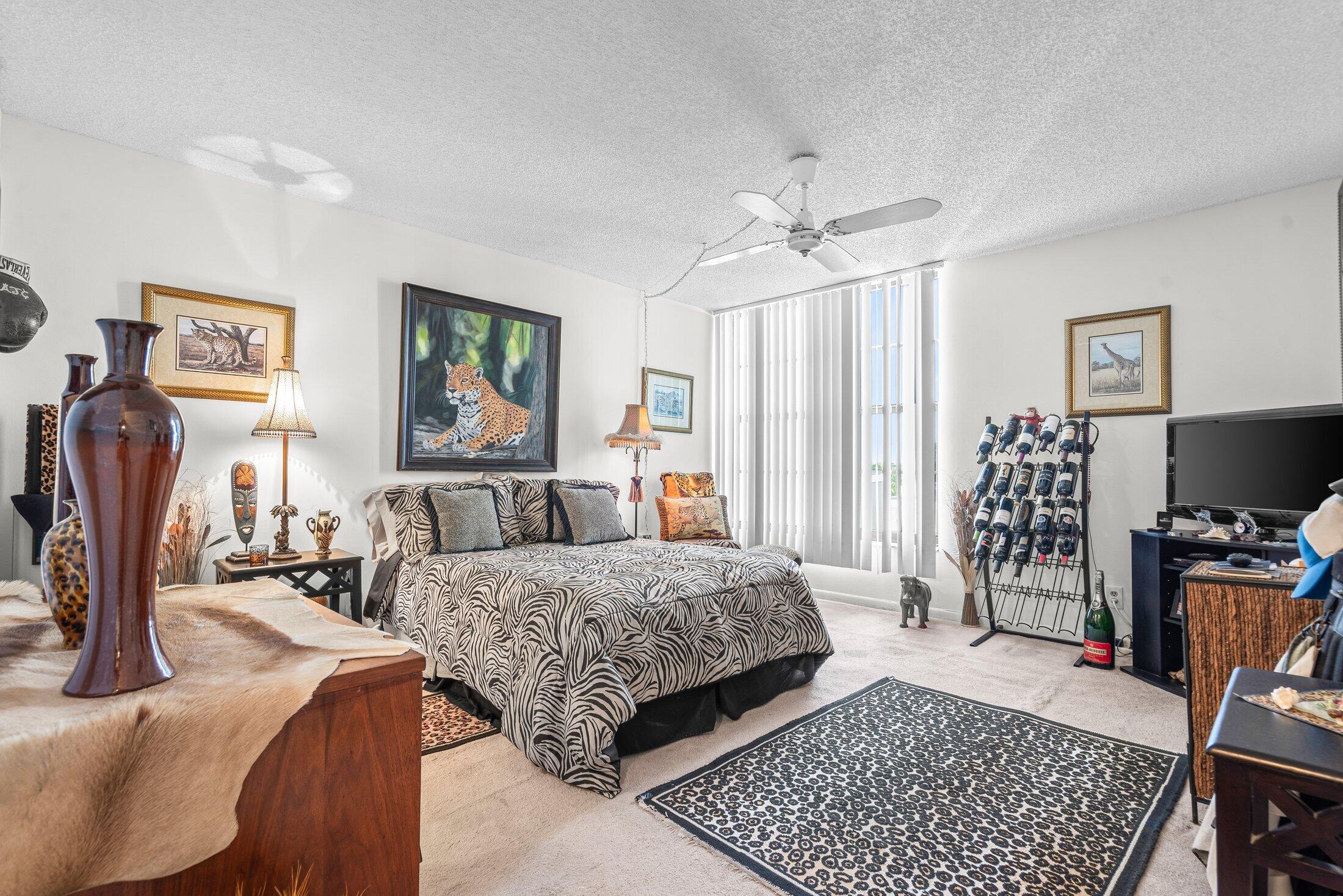 17 Royal Palm Way, Unit 504 Boca Raton, FL 33432 - Photo 20 of 44 a bedroom with a bed couch and a window