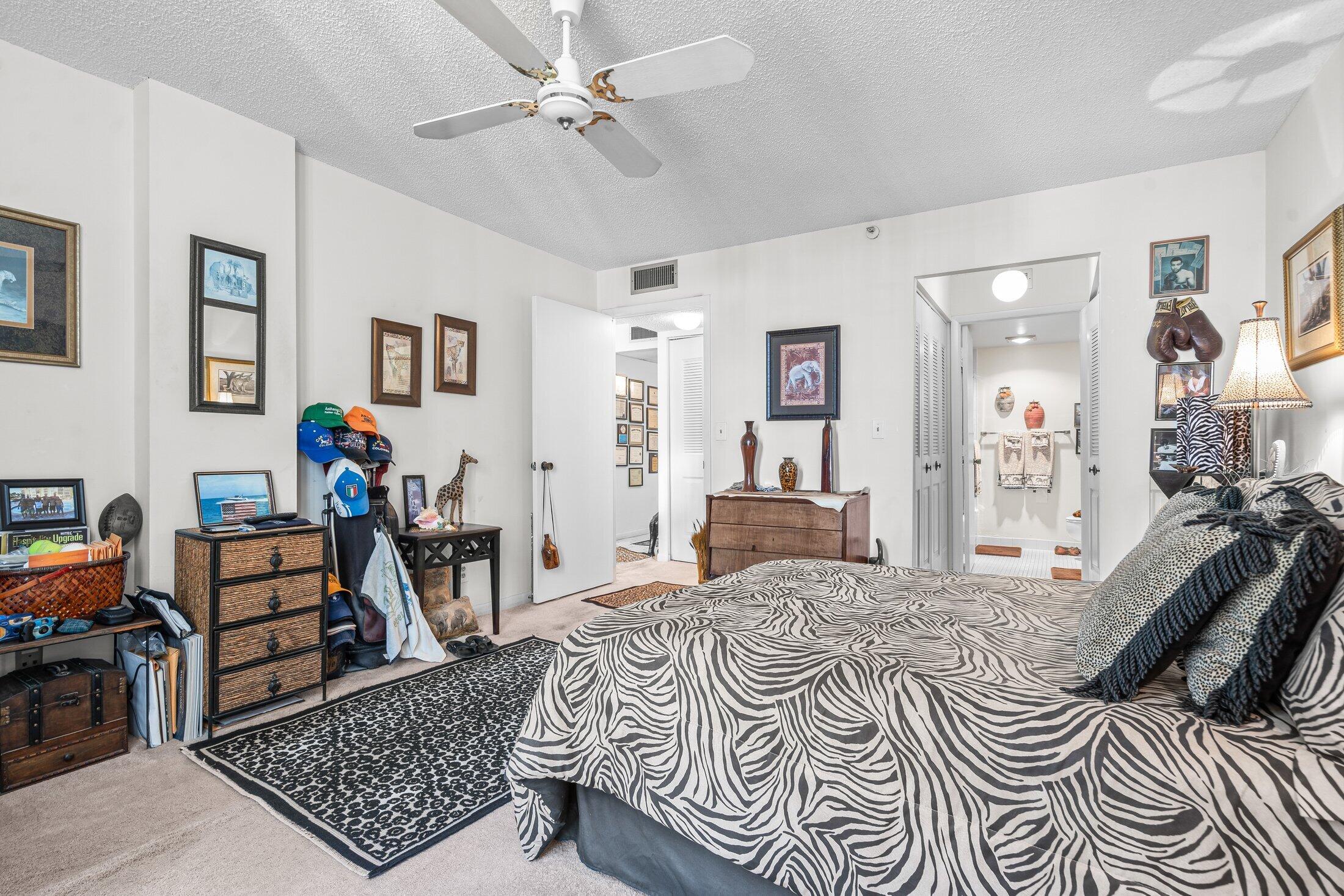 17 Royal Palm Way, Unit 504 Boca Raton, FL 33432 - Photo 21 of 44 a bedroom with furniture and a rug