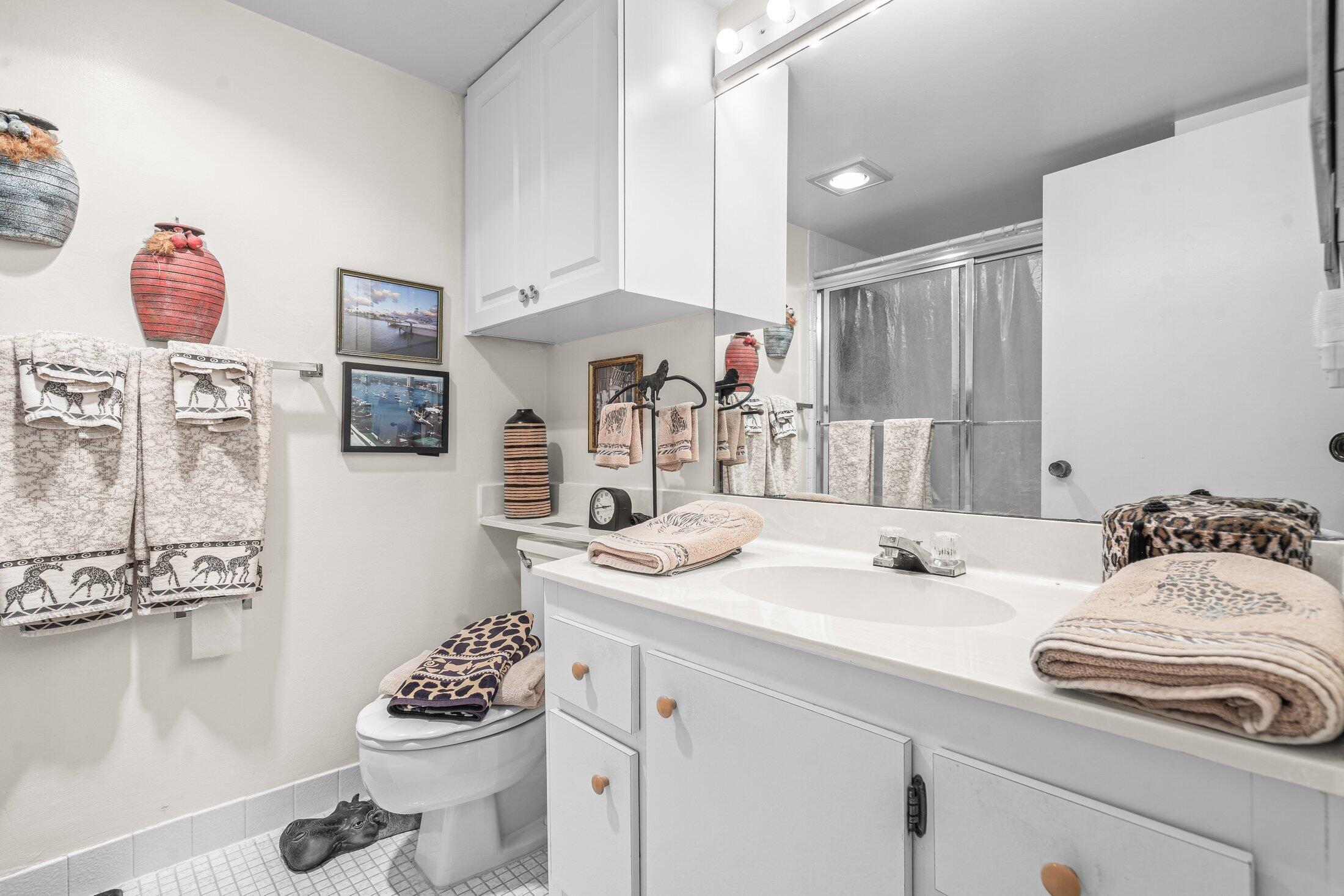 17 Royal Palm Way, Unit 504 Boca Raton, FL 33432 - Photo 22 of 44 a bathroom with a sink and a mirror