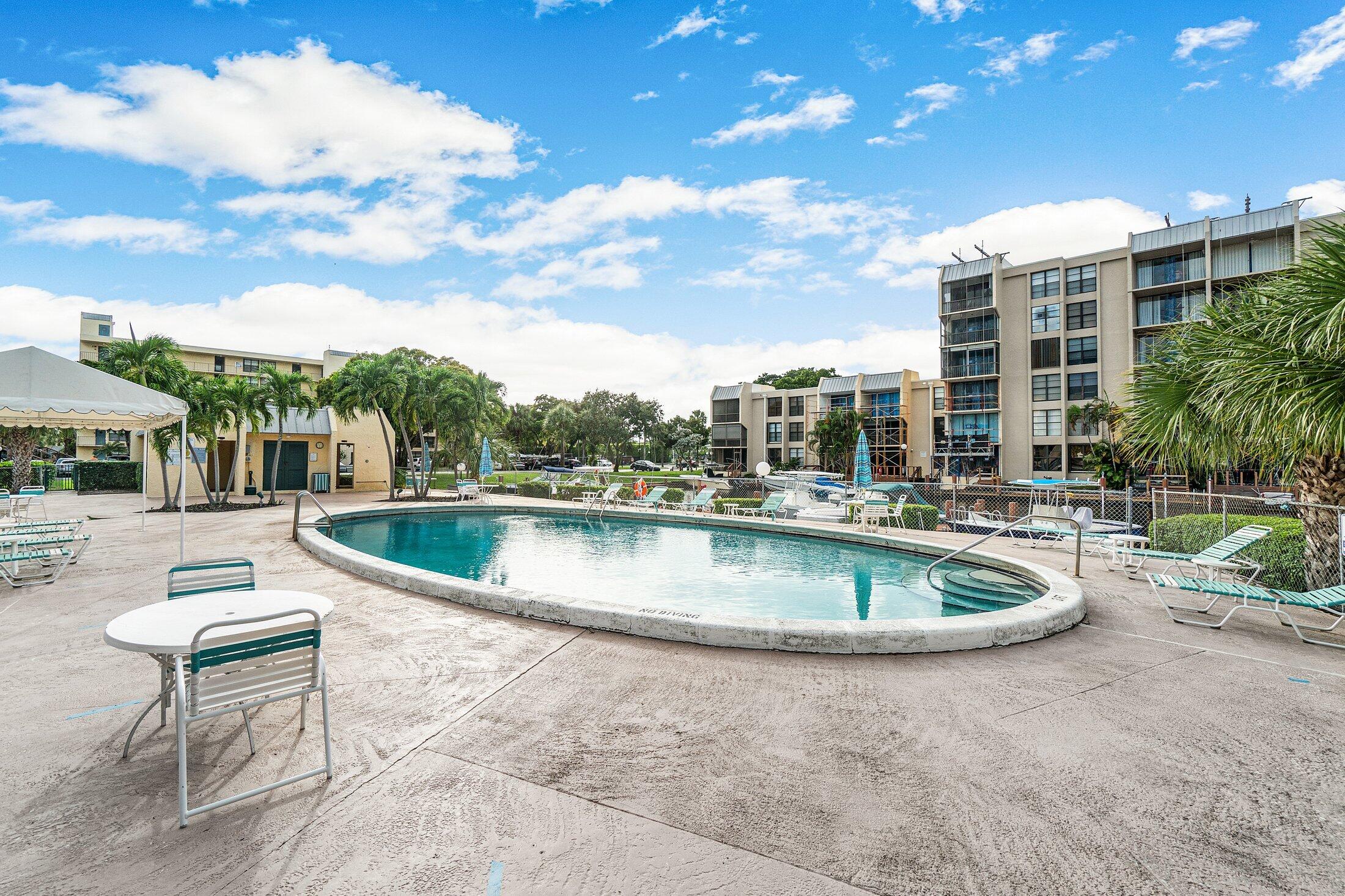 17 Royal Palm Way, Unit 504 Boca Raton, FL 33432 - Photo 42 of 44 a view of a swimming pool with a patio and a yard