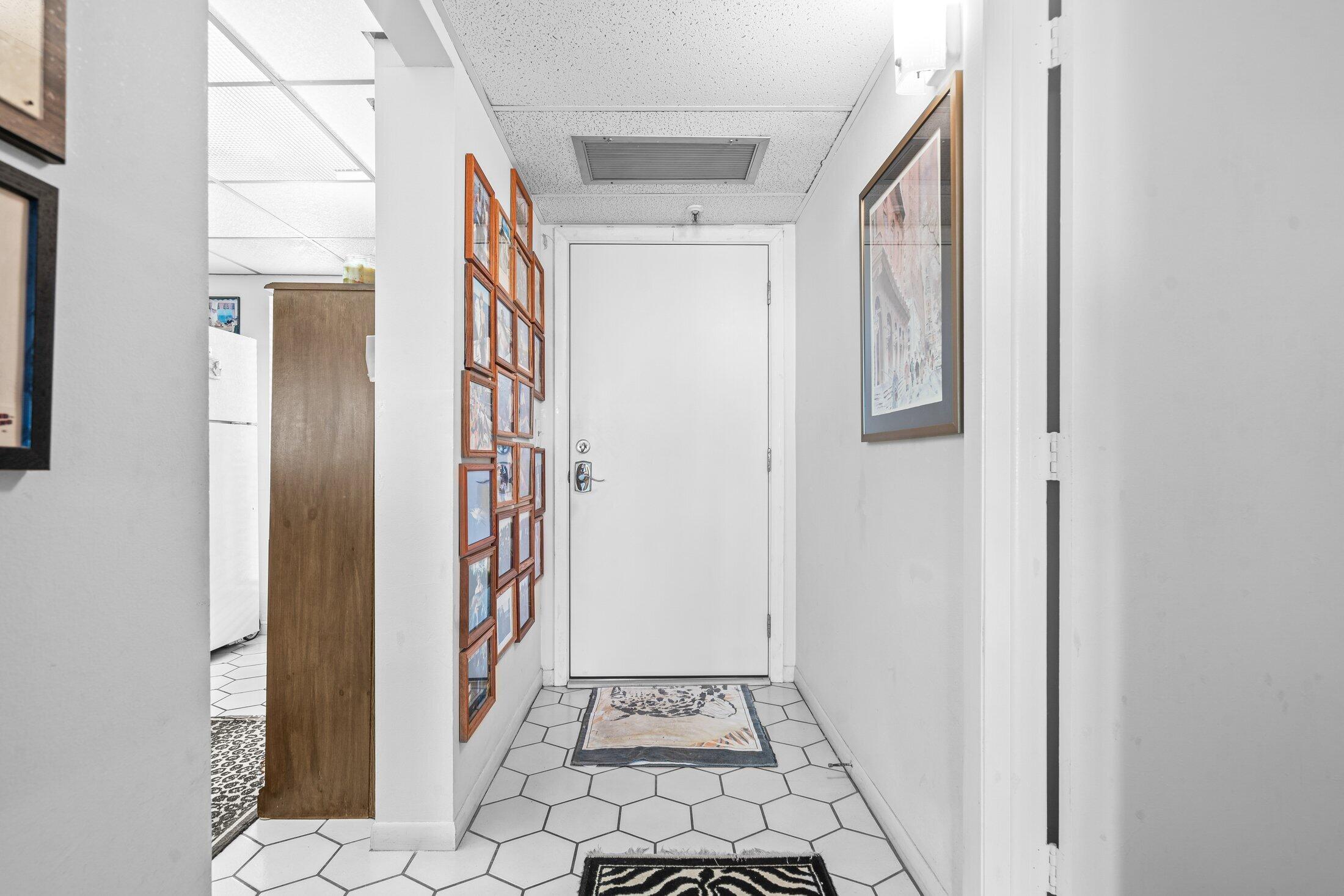 17 Royal Palm Way, Unit 504 Boca Raton, FL 33432 - Photo 5 of 44 a view of a hallway with wooden floor and a dining room