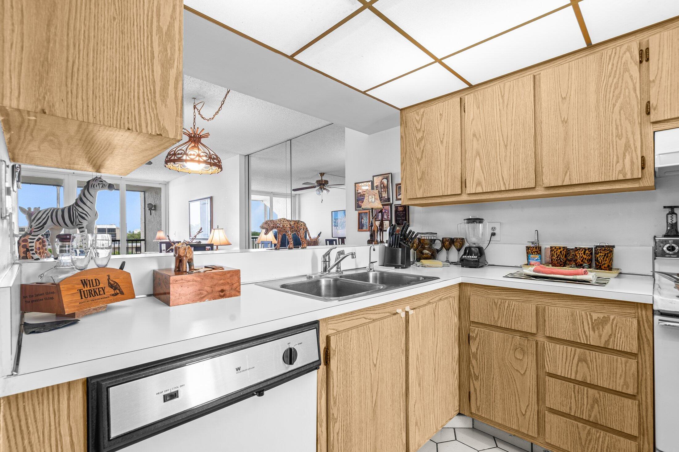 17 Royal Palm Way, Unit 504 Boca Raton, FL 33432 - Photo 8 of 44 a kitchen with stainless steel appliances granite countertop a sink dishwasher and cabinets with wooden floor