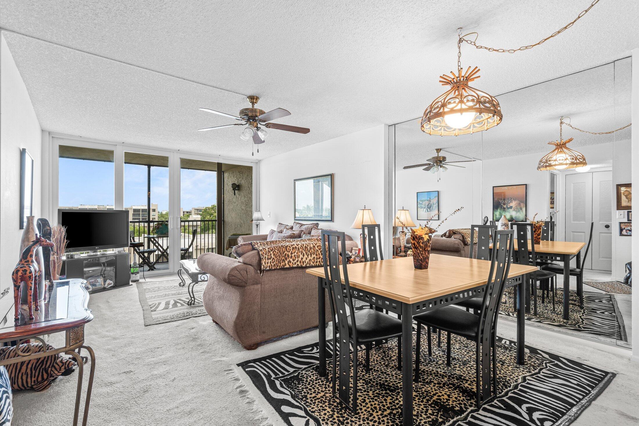 17 Royal Palm Way, Unit 504 Boca Raton, FL 33432 - Photo 9 of 44 a view of a dining room with furniture a chandelier and wooden floor