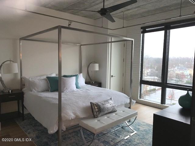 16 Old Track Road, Unit PH 2 Greenwich, CT 06830 - Photo 12 of 23 a bedroom with a bed window and a table