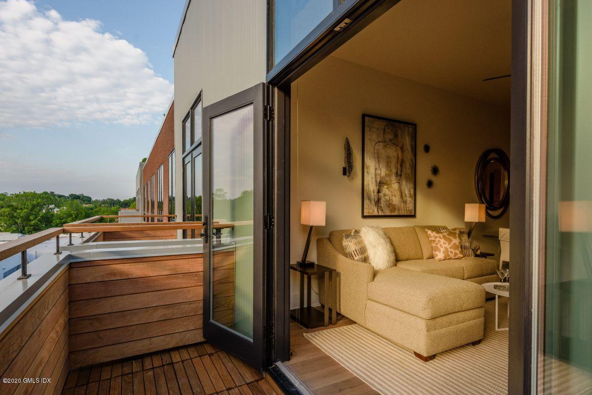 16 Old Track Road, Unit PH 2 Greenwich, CT 06830 - Photo 6 of 23 a view of a balcony with couch and wooden floor