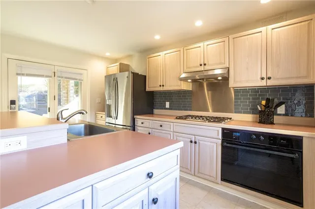 a view of a kitchen counter top space with furniture and wooden floor