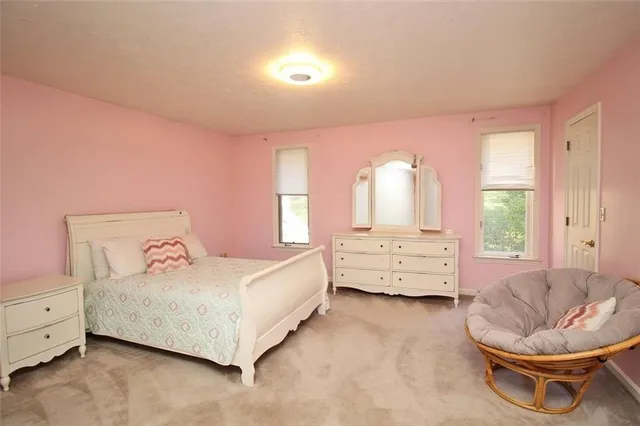 a bedroom with a bed and a television