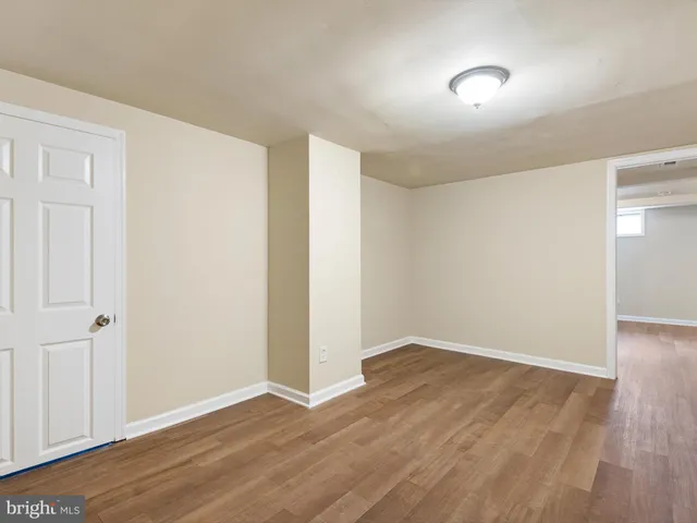 an empty room with wooden floor and closet